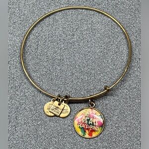Alex and Ani gold tone bangle bracelet w/Create Peace of Mind charm.